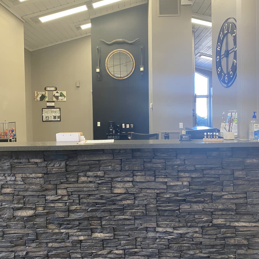 The stone reception desk at Goose Creek Dental Clinic.